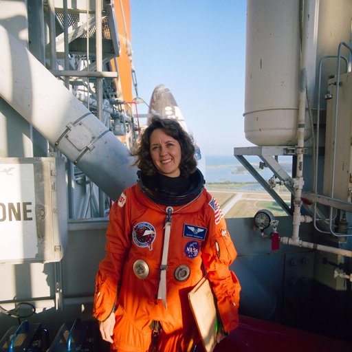 STS-33 MS Thornton on KSC LC Pad 39B 195 ft level with OV-103 in background