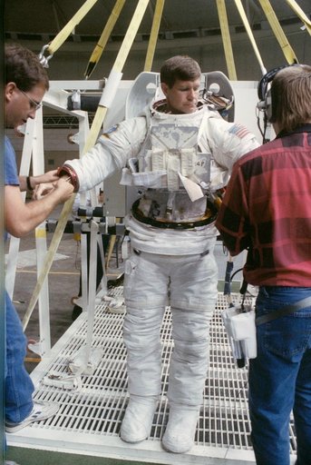 STS-39 MS McMonagle dons EMU for underwater EVA simulation in JSC's WETF