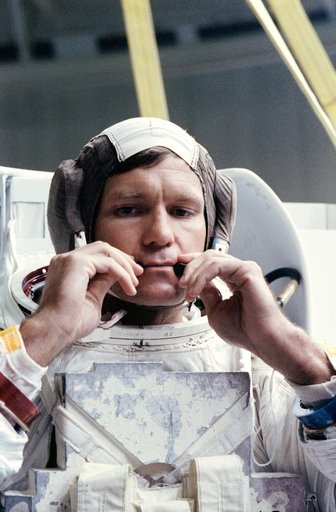STS-39 MS McMonagle adjusts CCA microphones prior to simulation in JSC's WETF