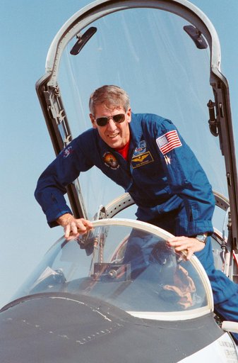 STS-38 MS Springer climbs into T-38A forward cockpit at Ellington Field