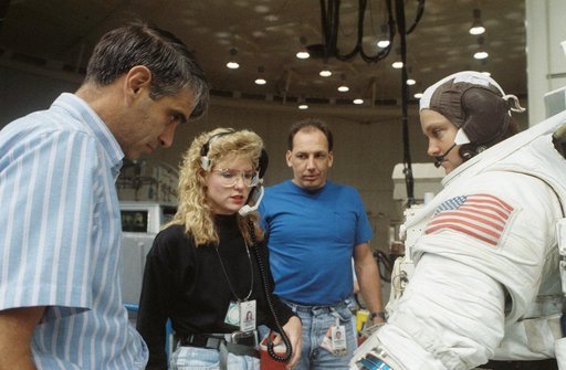 STS-40 MS Jernigan in EMU listens as Pilot Gutierrez looks on in JSC's WETF