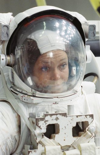STS-40 MS Jernigan wearing EMU prepares for a simulation in JSC's WETF pool
