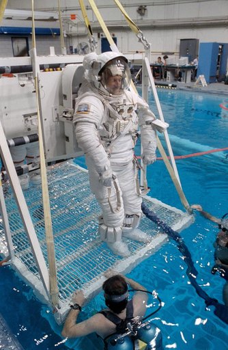 STS-45 MS Foale in EMU is lowered into JSC's WETF pool for underwater test