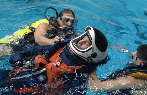 STS-52 Payload Specialist MacLean floats in pool during JSC bailout exercises