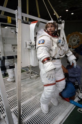 STS-54 MS3 Susan J. Helms dons EMU for underwater simulation in JSC's WETF