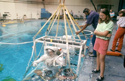 STS-53 MS Voss, in EMU, in lowered into JSC's WETF pool for EVA simulation