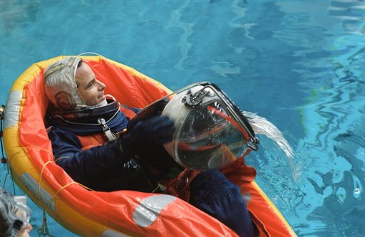 Astronaut Kevin P. Chilton uses helmet to bail water during bailout training