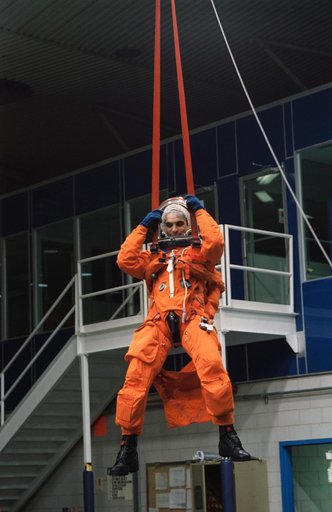 Astronaut Sidney Gutierrez suspended by parachute during bailout training