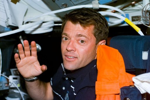 Pilot Ashby waves from the pilot's seat in the flight deck