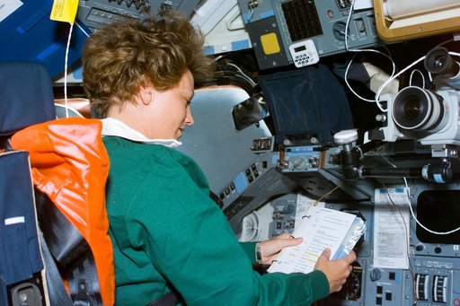 Commander Collins seated in the flight deck commander's station