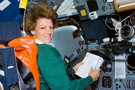 Commander Collins seated in the flight deck commander's station