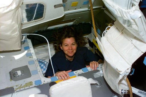 Coleman moves through interdeck hatch into the flight deck