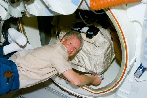 MS Hawley packs a stowage bag into the airlock of Columbia