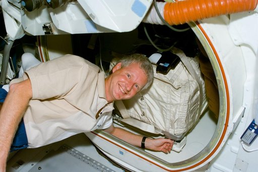 MS Hawley packs a stowage bag into the airlock of Columbia