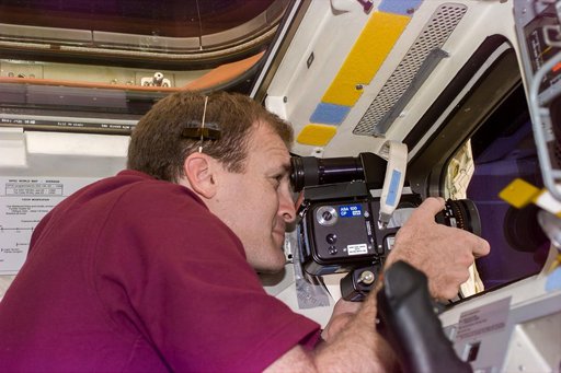 Cmdr Halsell on flight deck with camera
