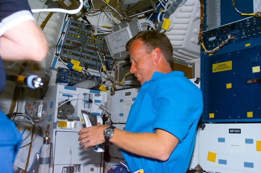 Lindsey rehydrates drink packet on middeck