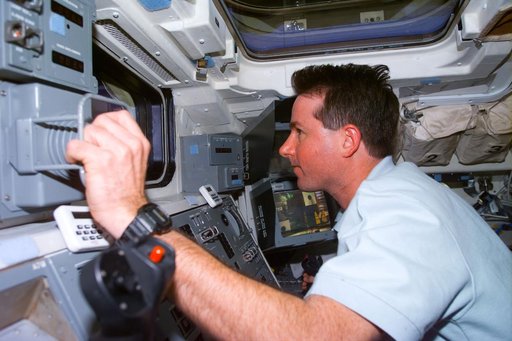 Robinson at RMS control on flight deck during SPARTAN capture