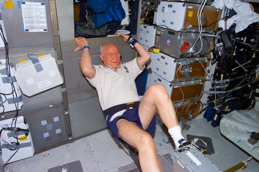 Glenn exercises on ergometer while on middeck
