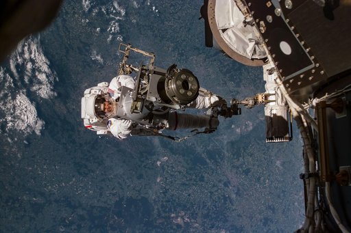 Tamara Jernigan transfers STRELA Grapple Fixture adapter during EVA