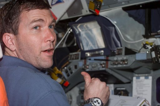 Rick Husband gives thumbs-up from flight deck during rendezvous