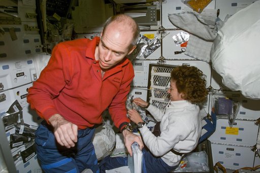 Daniel Barry and Ellen Ochoa on middeck with food