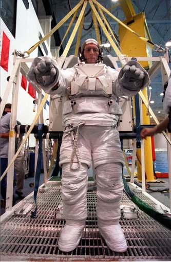 STS-99 crewmembers Kavandi and Thiel suit up in EMUs for NBL training