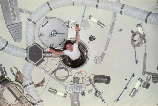 Astronaut Edward Gibson sails through airlock module hatch