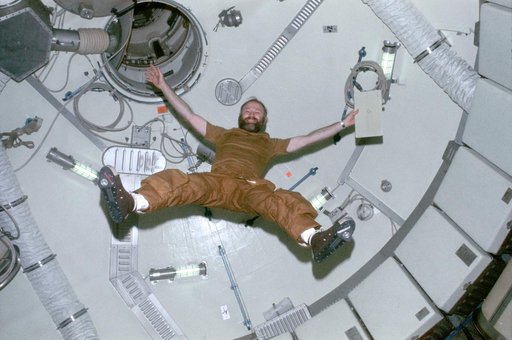 Astronaut Gerald Carr floats in forward dome area