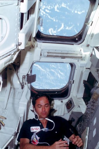 Pilot Crippen eats rehydrated food at aft flight deck onorbit station
