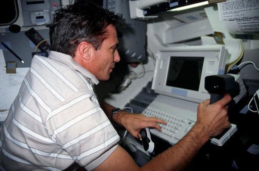 STS-43 Commander Blaha conducts DTO 1208 using laptop on OV-104's flight deck