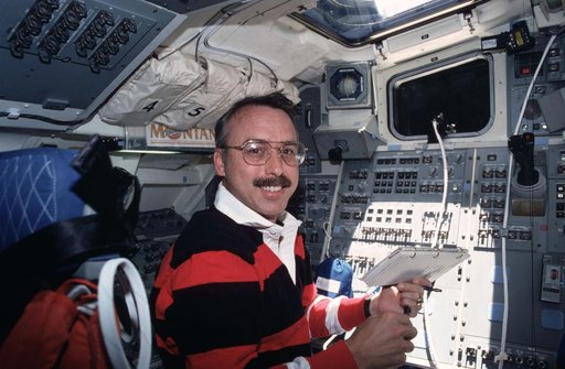 STS-43 MS Adamson checks OCTW experiment on OV-104's aft flight deck