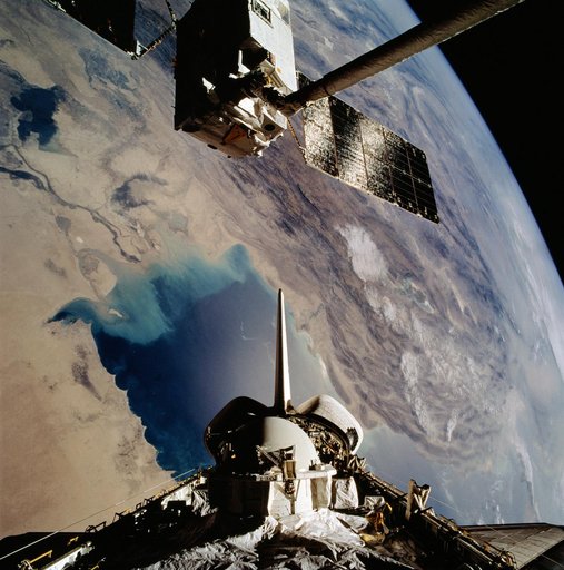 OV-104's RMS grapples EURECA-1L and holds it in deployment position above PLB