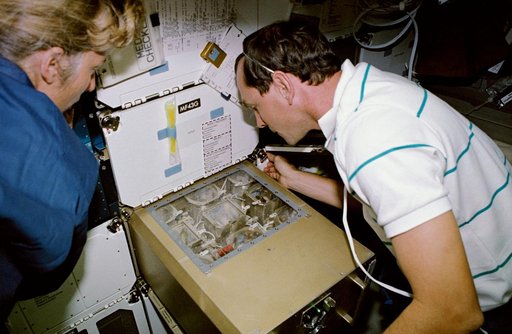 STS-47 MS Davis and Pilot Brown monitor ISAIAH on OV-105's middeck