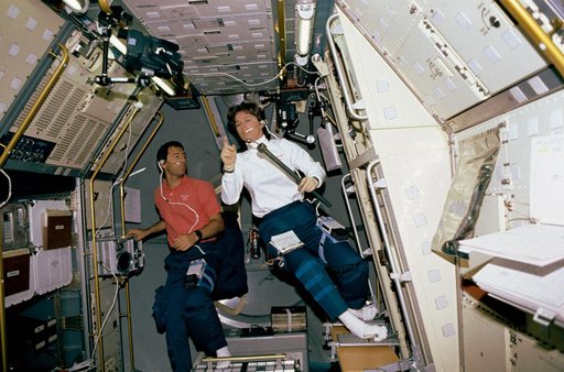 Crewmember working on the spacelab Drop Physics Module, Rack 9.