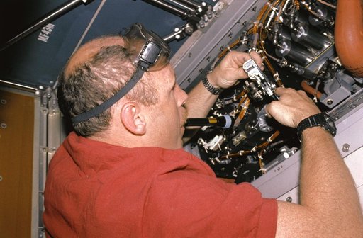 Crewmember repairing the Regenerative Carbon Dioxide Removal System wiring.