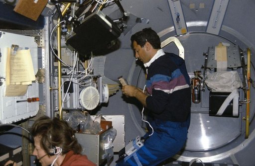 Crewmembers in the spacelab with Generic Bioprocessing Apparatus, Rack #10.