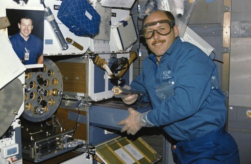 Crewmember in the mid deck with the Zeolite Crystal Growth experiment.
