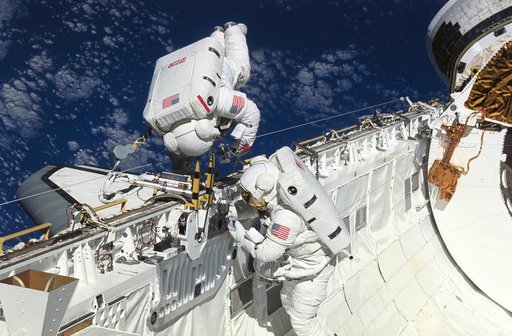 Astronauts Newman and Walz evaluate tools for use on HST servicing mission