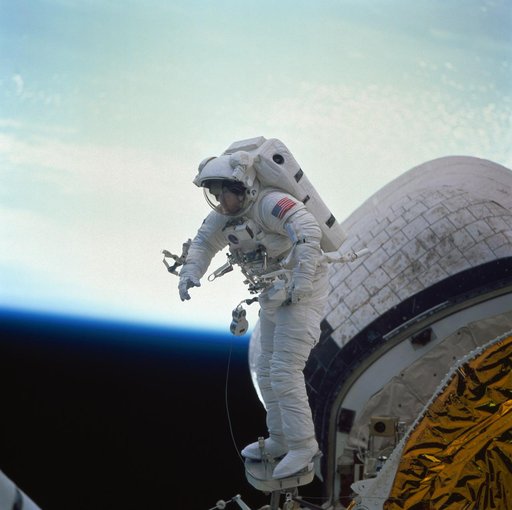 Astronaut James Newman during in-space evaluation of portable foot restraint