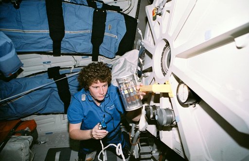 Crewmember in the middeck with Commercial Generic Bioprocessing experiment.