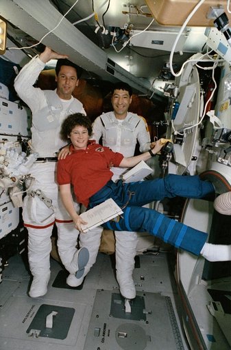 Mission Specialists Mario Runco and Greg Harbaugh suiting up for EVA.