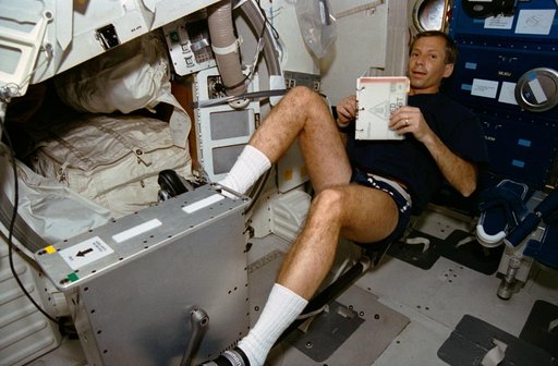 STS-56 MS2 Cockrell pedals reclining cycle ergometer on OV-103 middeck