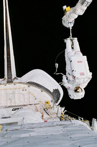 EVA crewmembers with the RMS, working in the aft payload bay.