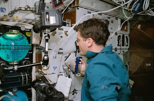 STS-57 MS3 Wisoff monitors FARE II activity on the middeck of OV-105