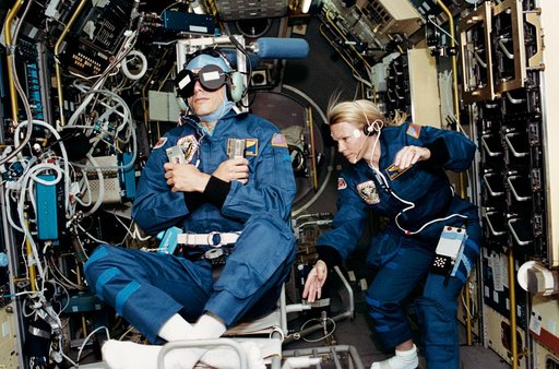 Crewmember in SPACELAB wearing the Acceleration Recording Unit and Collar.