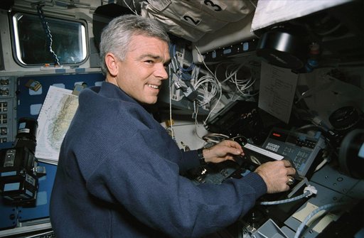 Astronaut Rich Clifford inserts tape into payload high data recorder