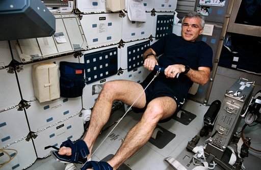 Crewmember in the middeck exercising on the MK-1 rowing machine (DTO 653).