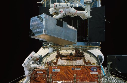 Astronauts Thornton and Akers in payload bay during EVA to replace COSTAR
