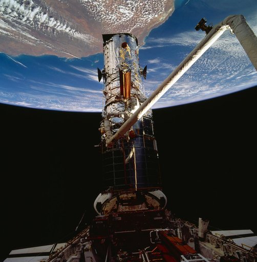Astronauts Akers and Thornton remove one of HST solar arrays during EVA