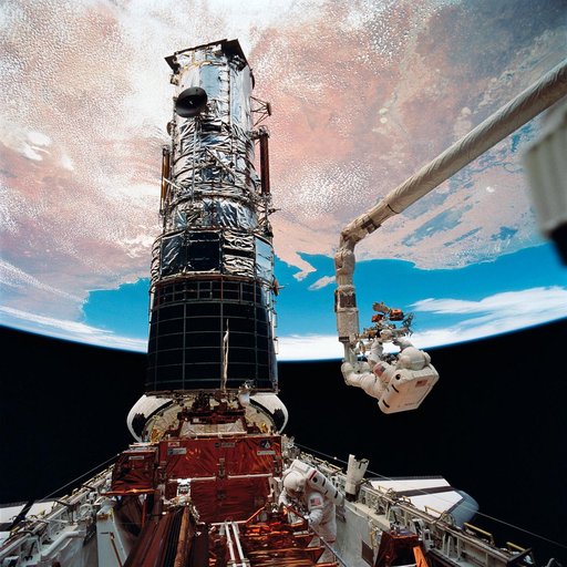 Astronauts Musgrave and Hoffman during servicing of HST